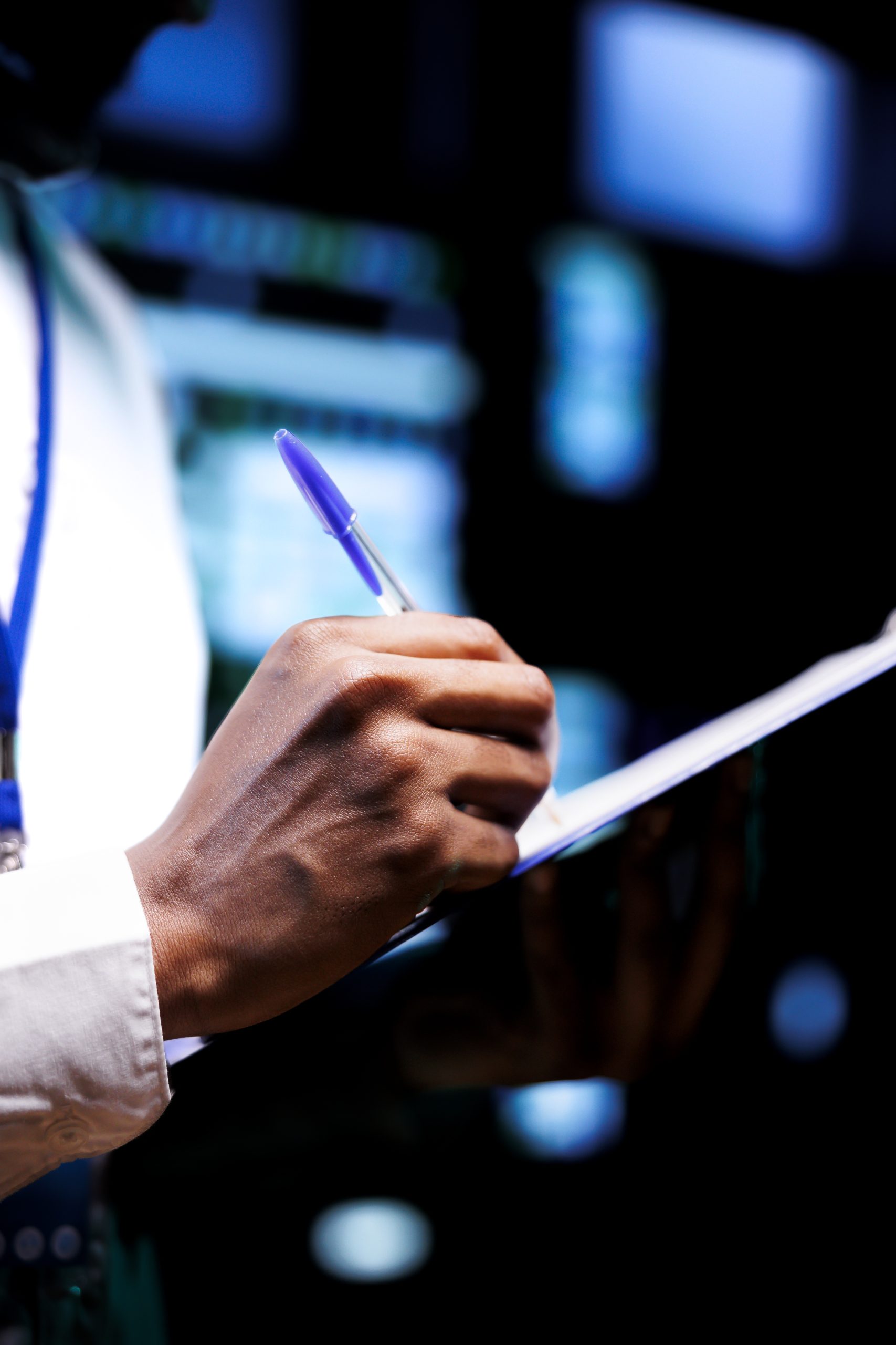 Close up shot of diligent engineer equipped with maintenance checklist in data center. Admin carefully examining critical systems in high tech establishment searching for irregularities